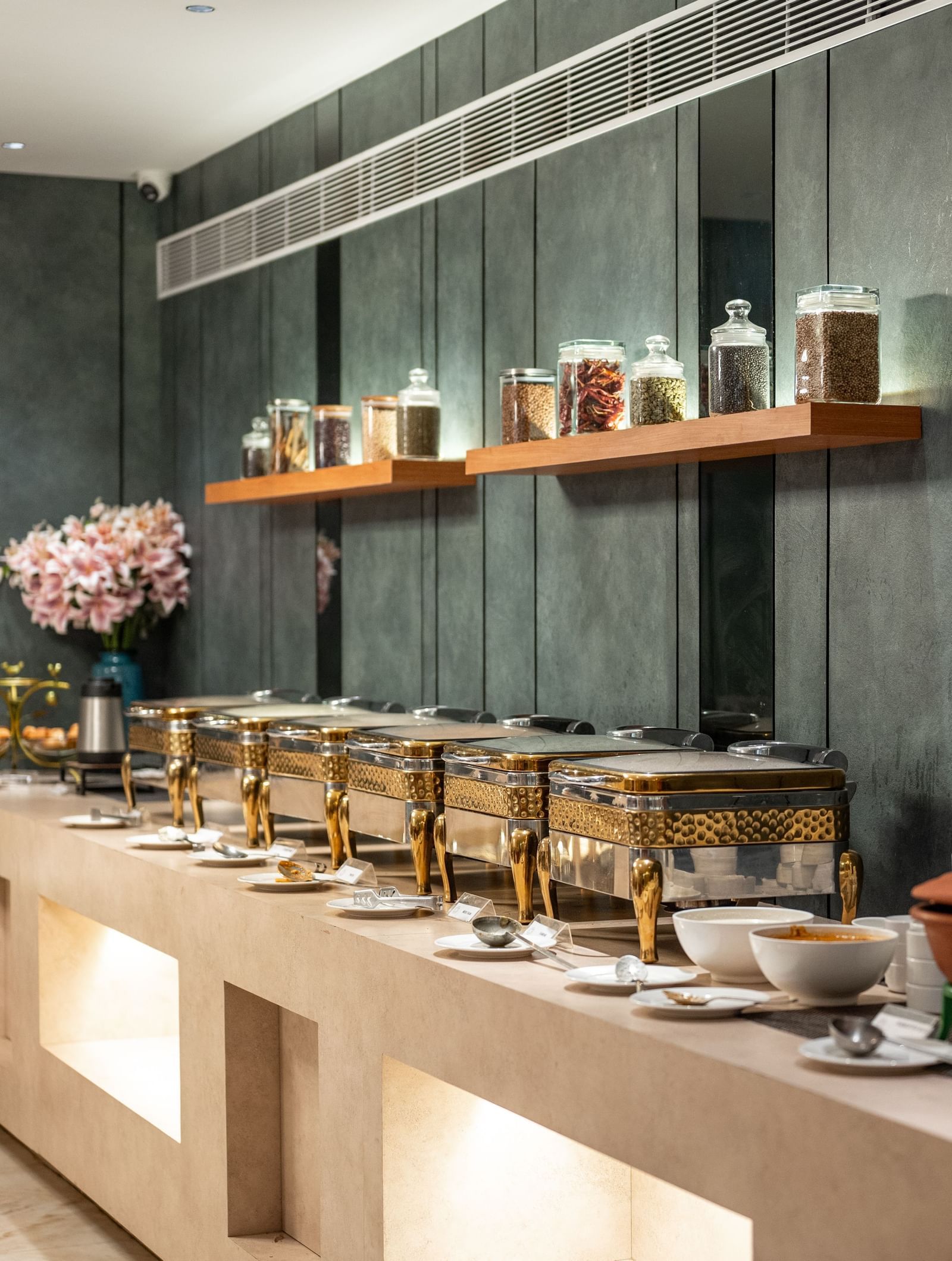 Buffet spread with assorted jars and traditional pots at Hotel Royal Regency Chennai