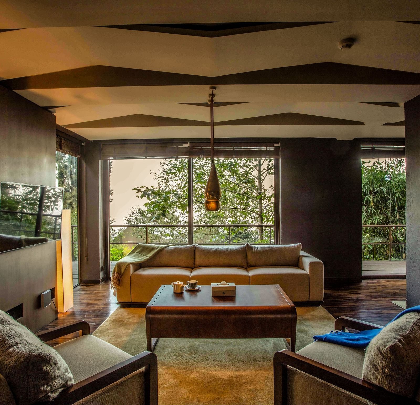 Natural light flooding a living room which has a couch and a centre table | Kavya Resort and Spa, Nagarkot