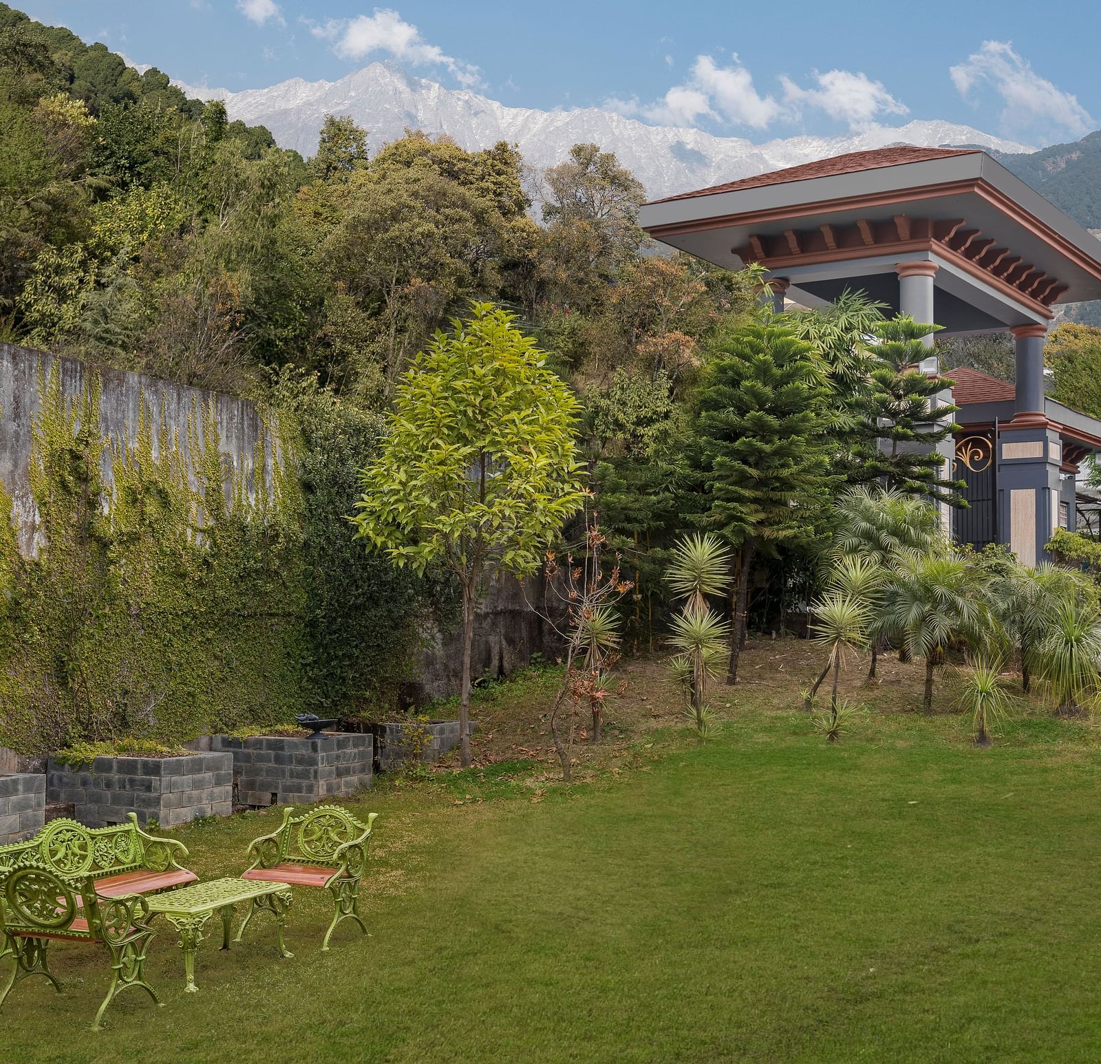 front view of the front lawn with tables and chairs and the property visible on the right - Atman, Dharamshala
