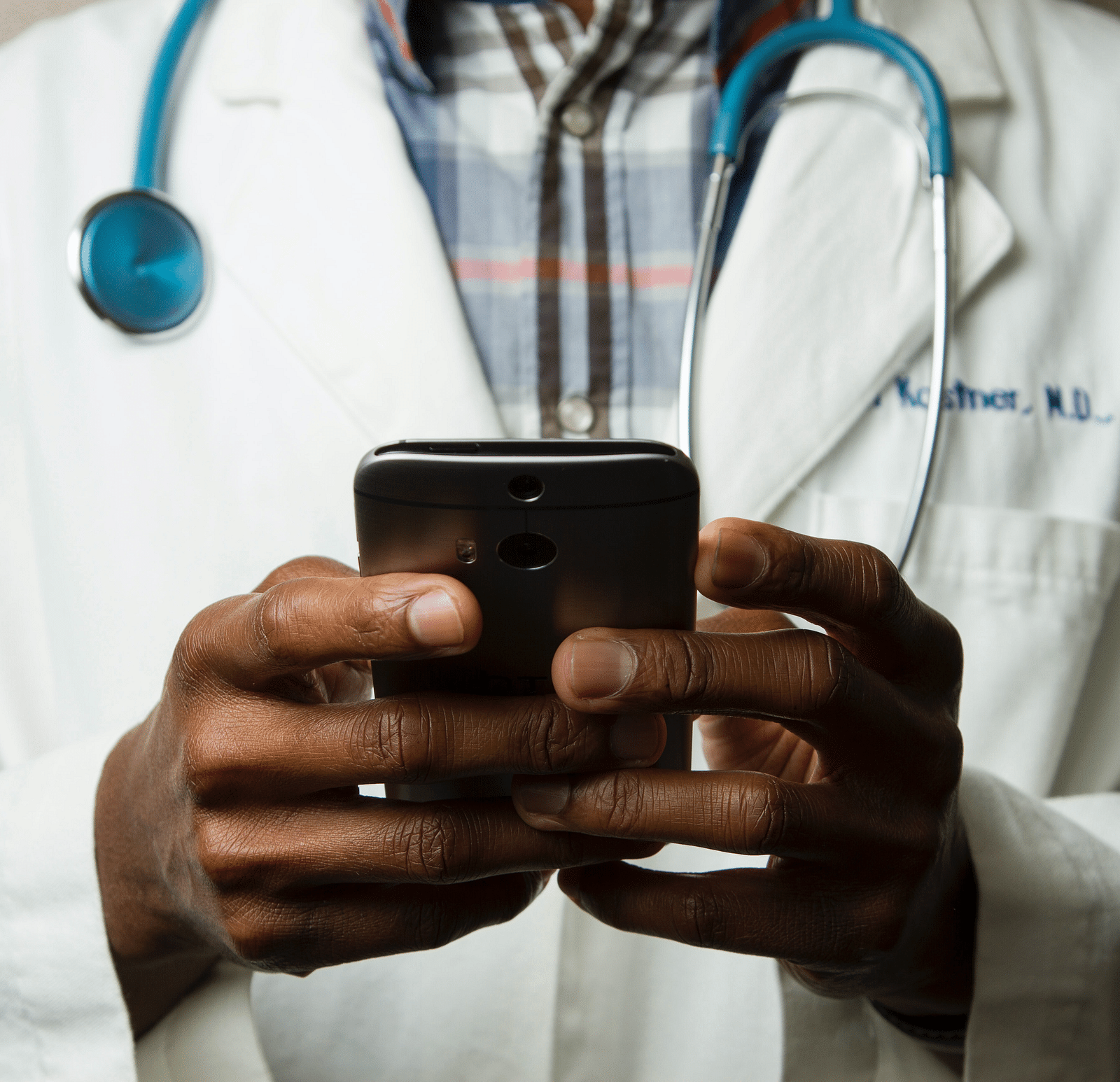 A picture of a doctor holding a phone
