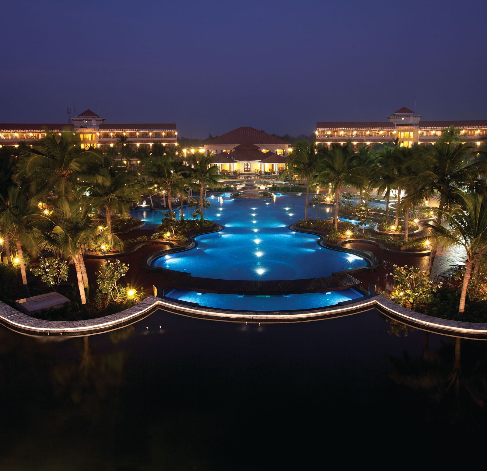 Wide angle Night View of the swimming pool and facade at Ocean Spray, Pondicherry.