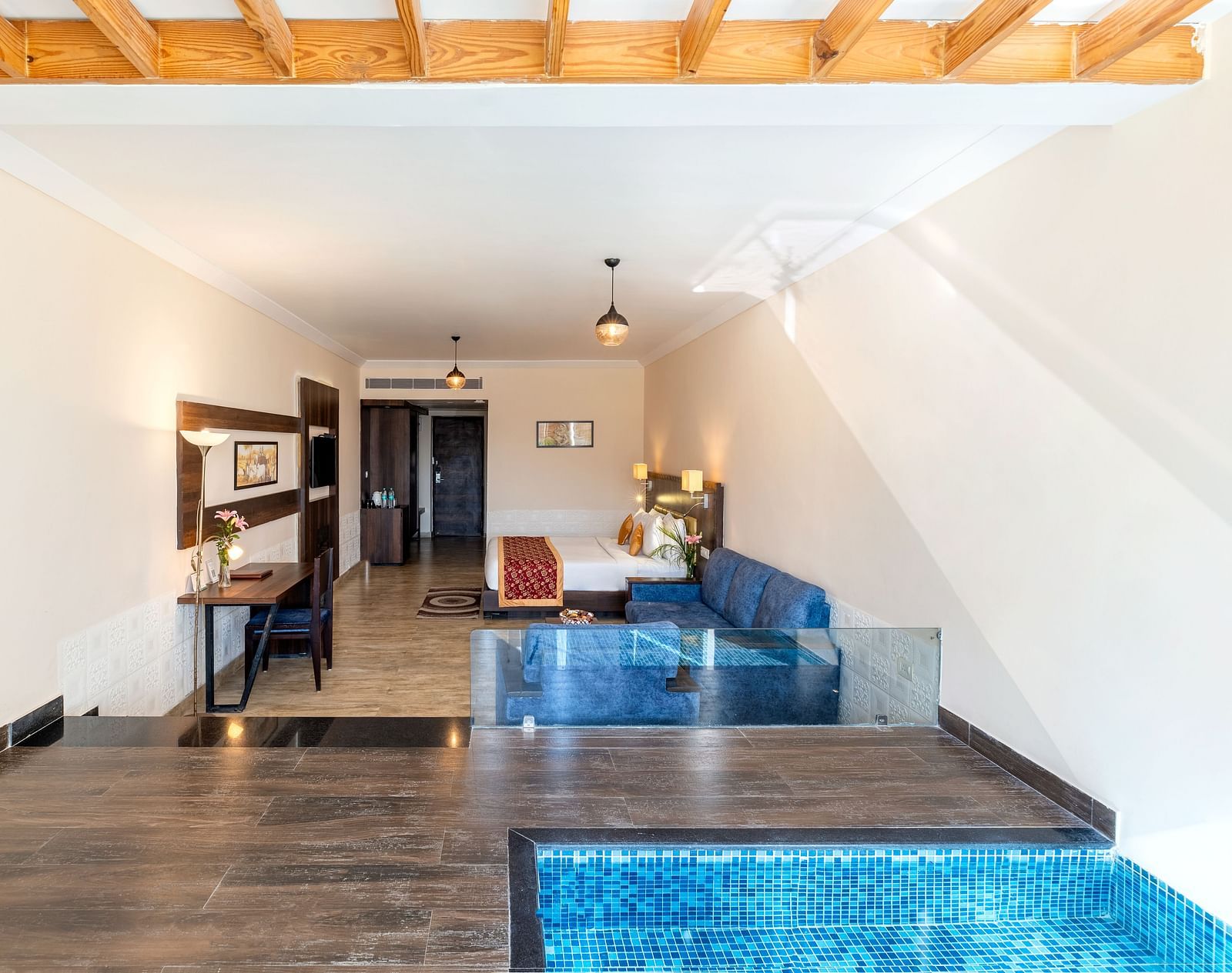 A hallway with a door leading to a room with small plunge pool - Via Lakhela Resort & Spa