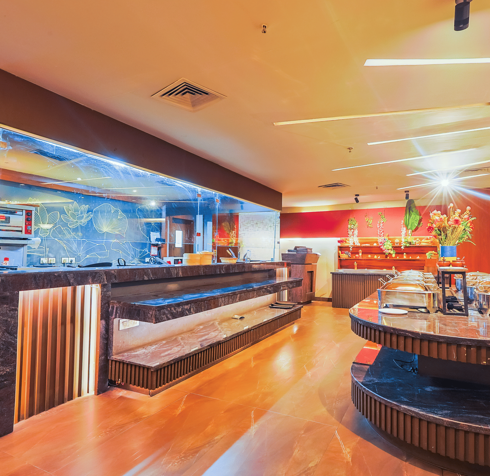 The contemporary serving area of a restaurant with wooden panelling and warm lighting - Hyphen Business Hotel, Noida