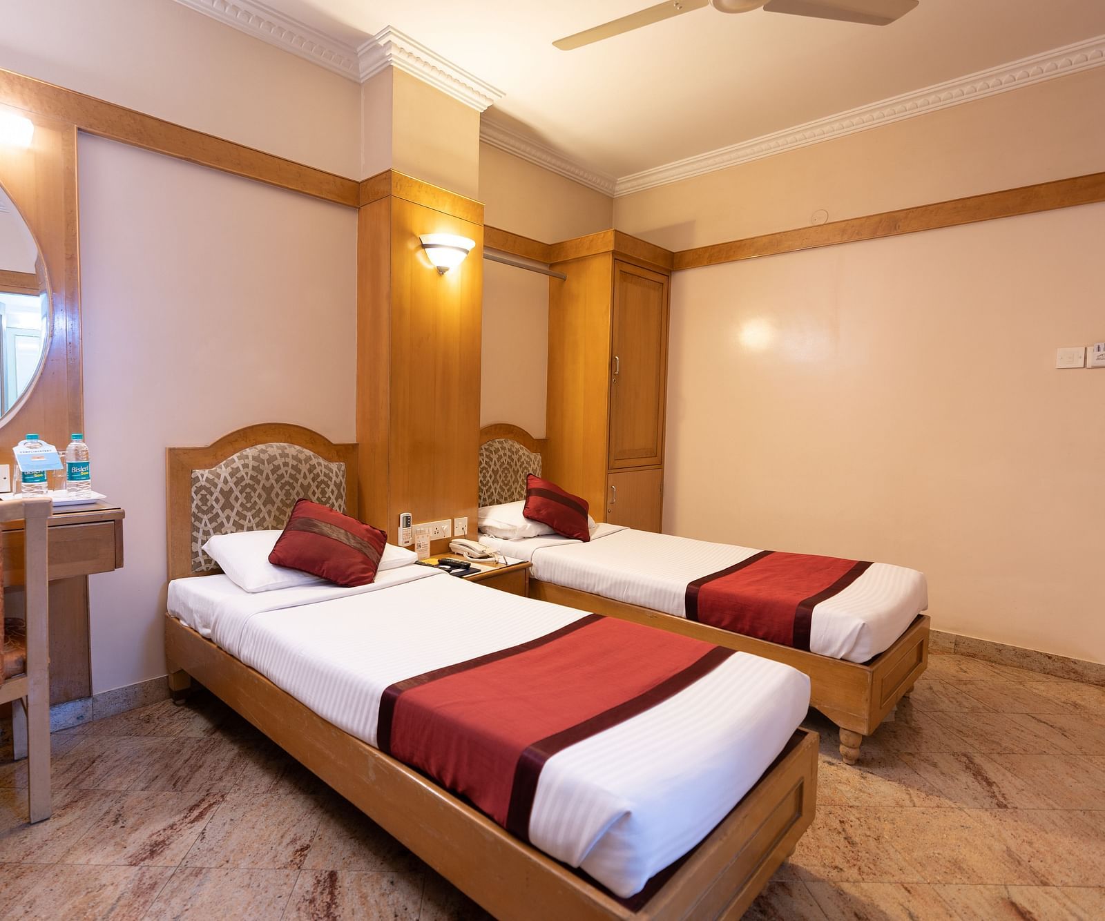 twin beds with a sofa on the side inside one of the rooms - Hotel Pai Comforts, JP Nagar