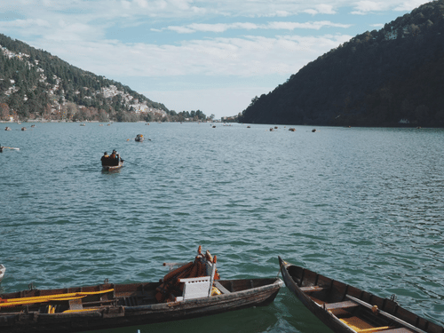 Boating on the serene waters of lake near mountains