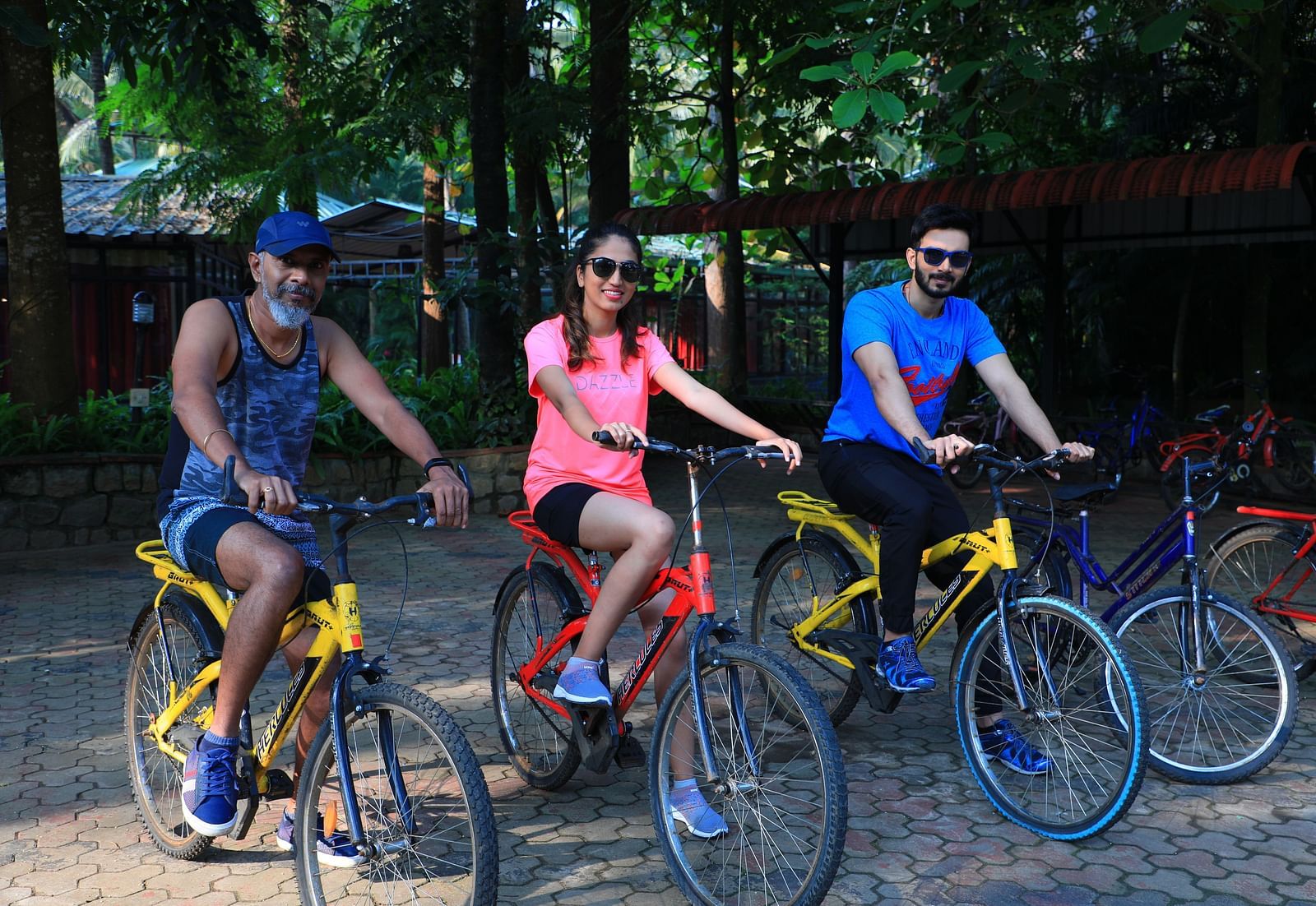 Image of three people on a cycle posing for the lens.