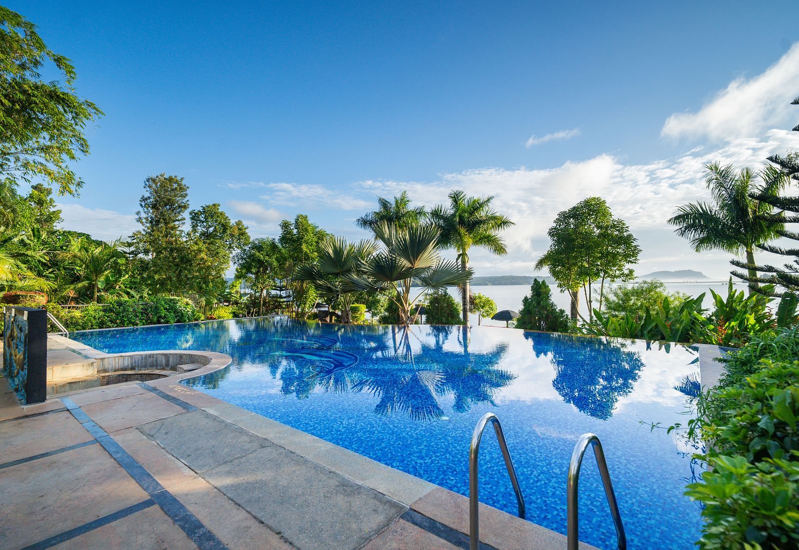 Image of a swimming pool with trees surrounding it at Coorg Jungle Camp Backwater Resort, Kushalnagar.