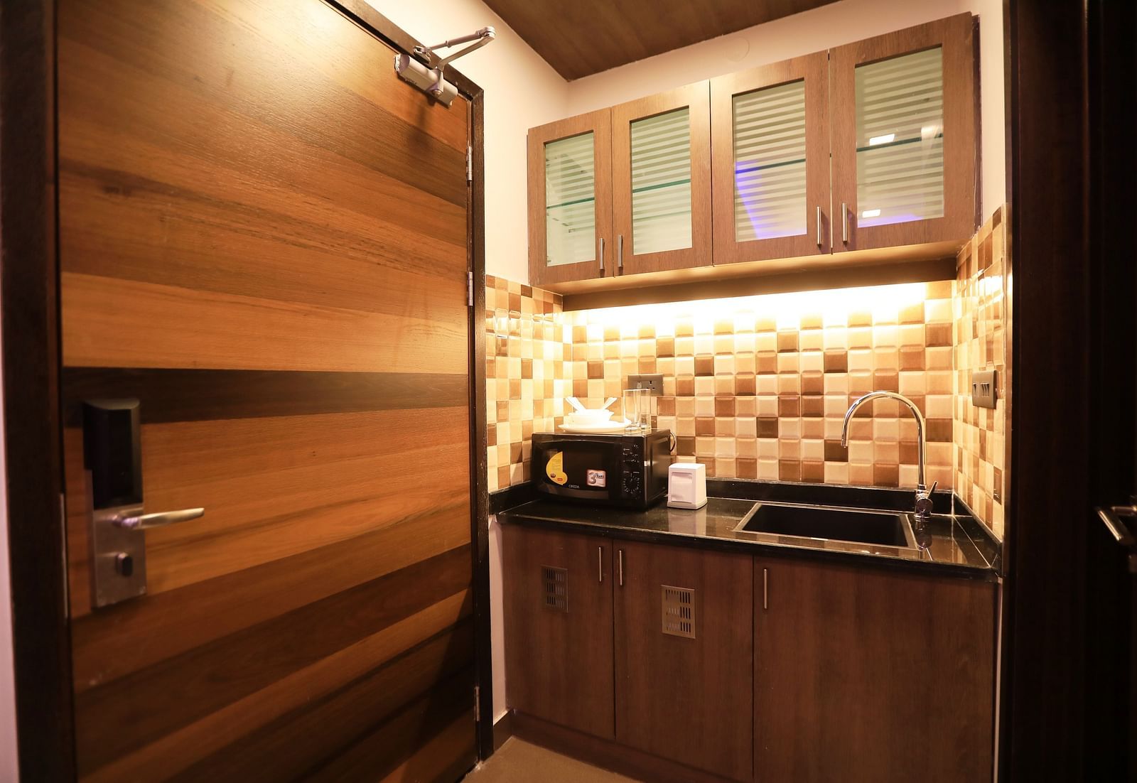 Image of a kitchen area with a sink and modern amenities at Hotel Altitude, Madikeri.