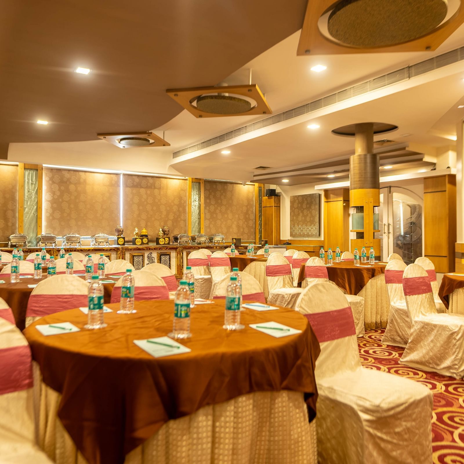 A banquet hall at Hotel Pai Viceroy Jayanagar in a wedding setup featuring ambient lighting