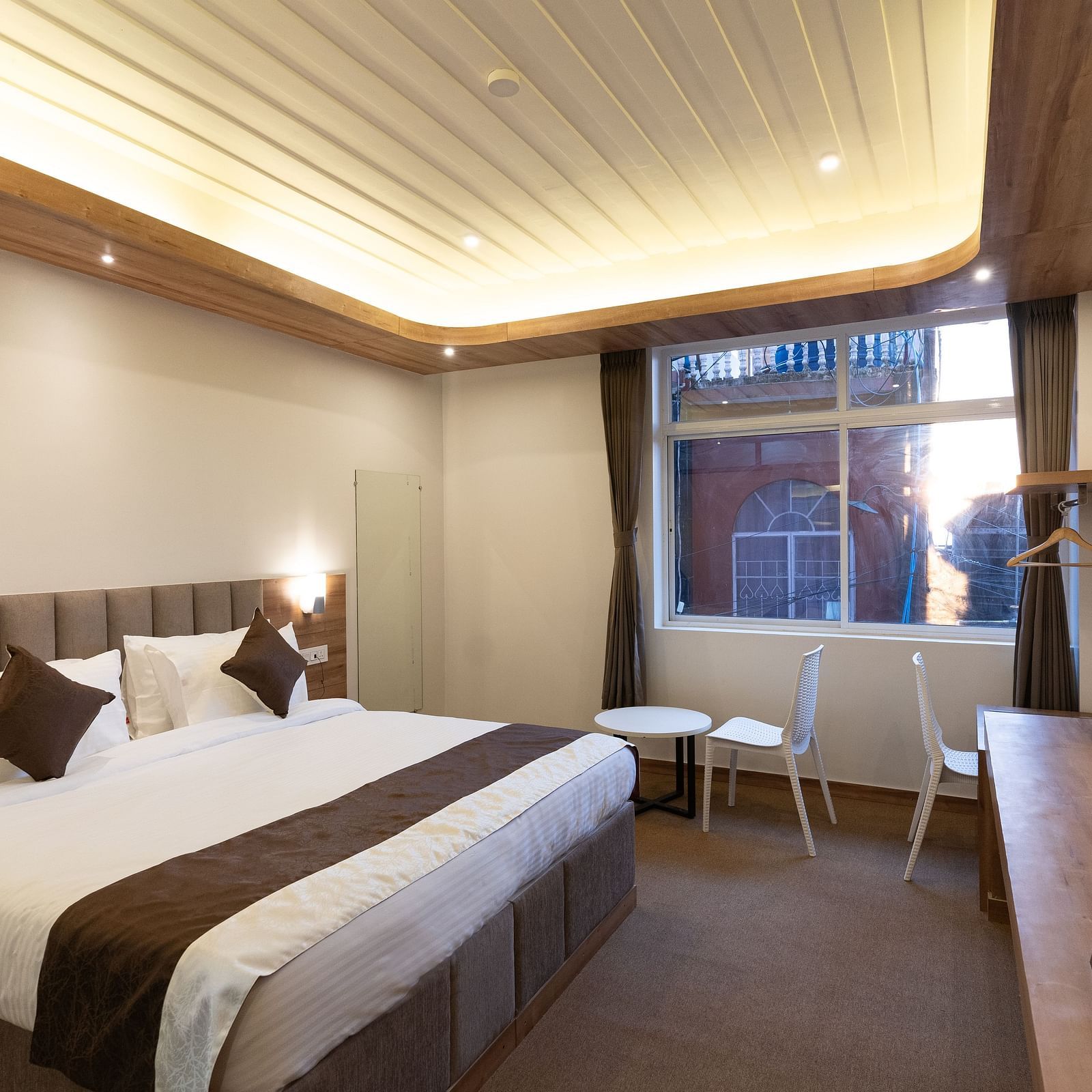 image of the standard room with a window in the corner at The Soma Hotel by Avianna Group, Darjeeling
