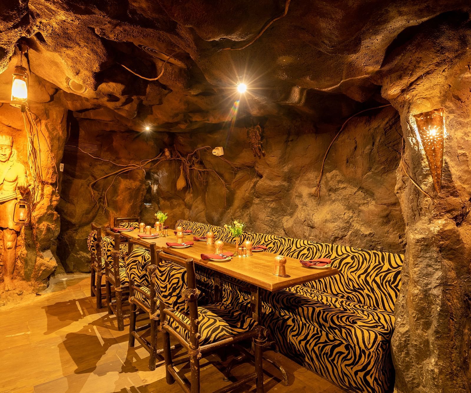 Seating arrangements inside the restaurant with dim lights - Hotel Pai Vista, Mysore
