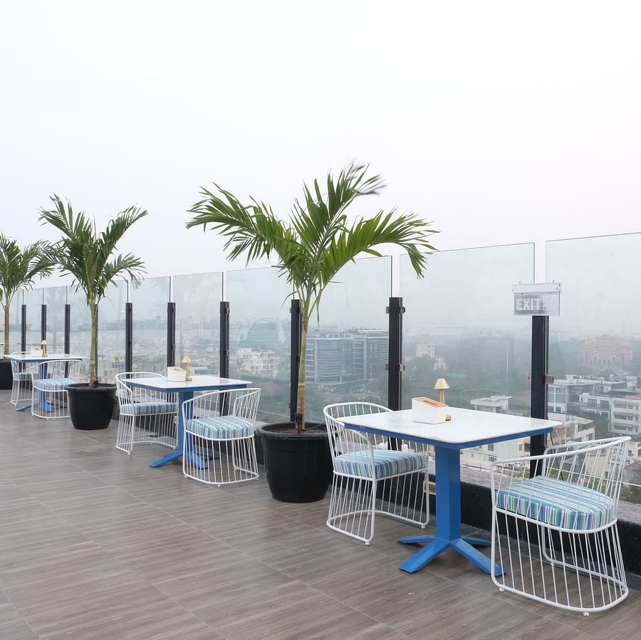 The two seater tables with balcony view at ta BLU Rooftop Bar at Clarks Amer, Jaipur