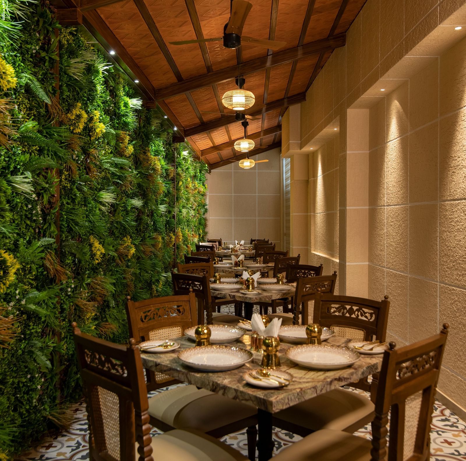 An image of dining space with vertical garden along the side - The President Hotel, Kumara Park, Bangalore