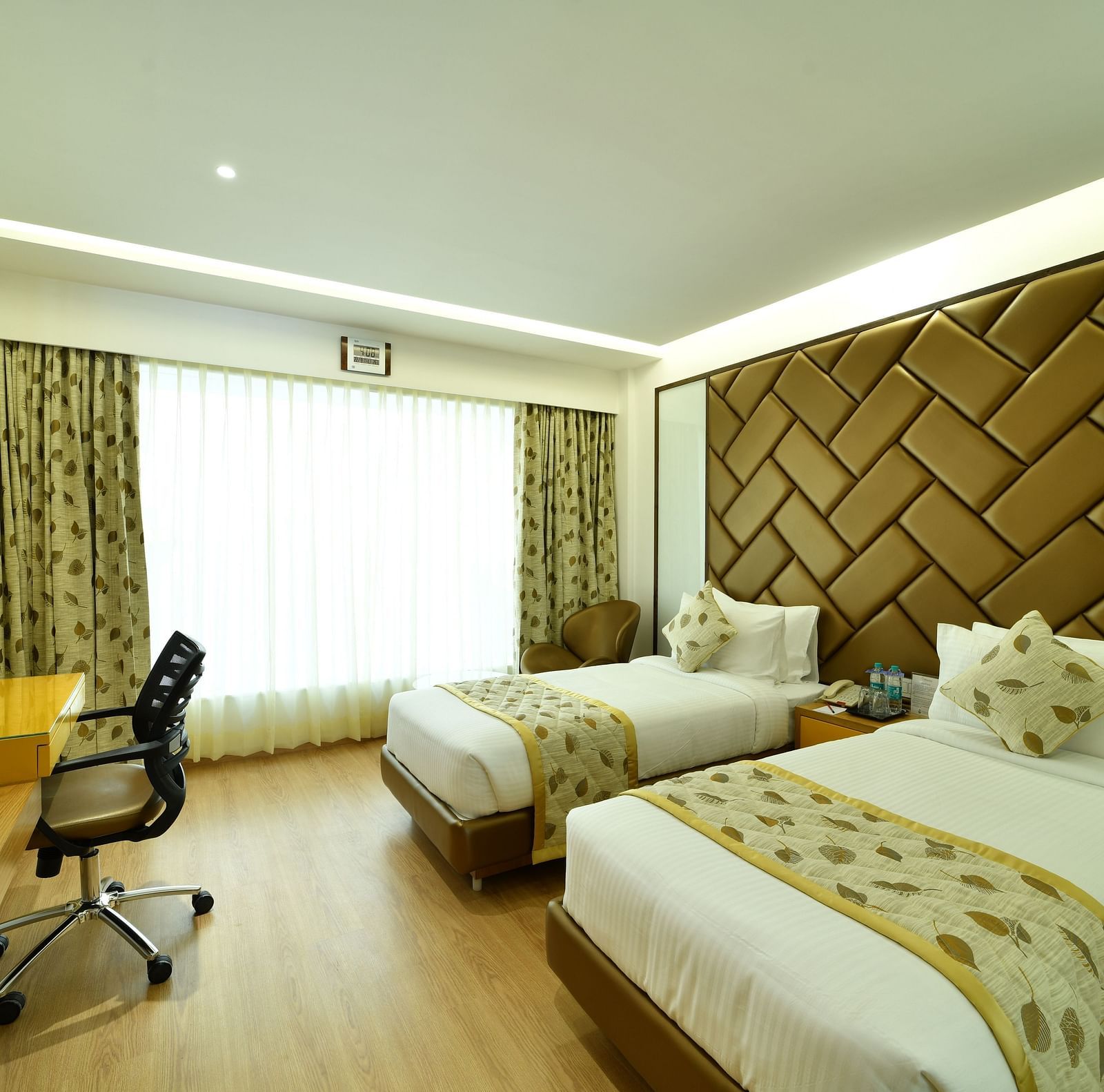 An image of a bedroom with twin beds and a television - The President Hotel, Kumara Park, Bangalore