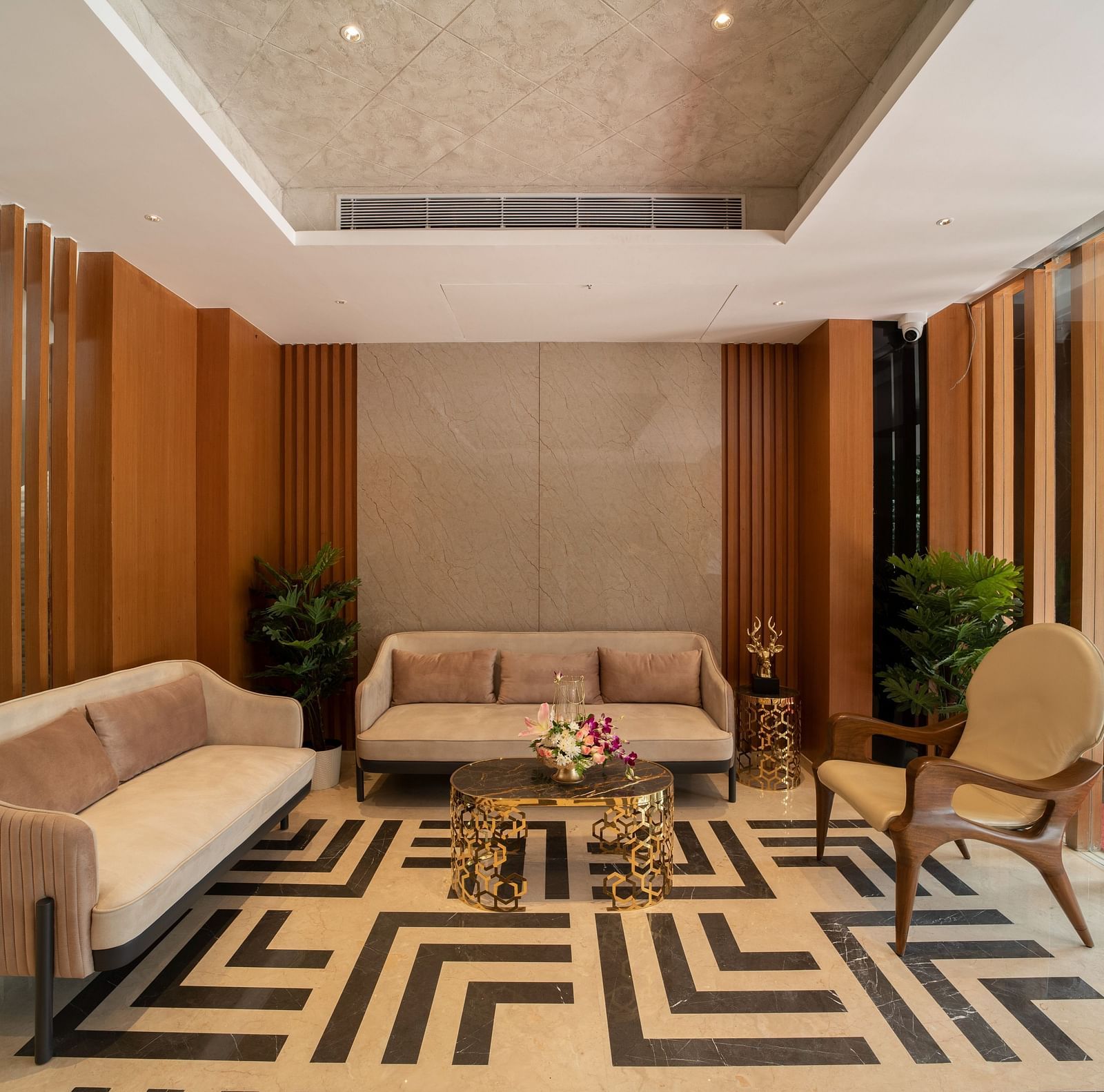 An image of hotel lobby area with geometric patterned flooring and sofas - The President Hotel, Kumara Park, Bangalore