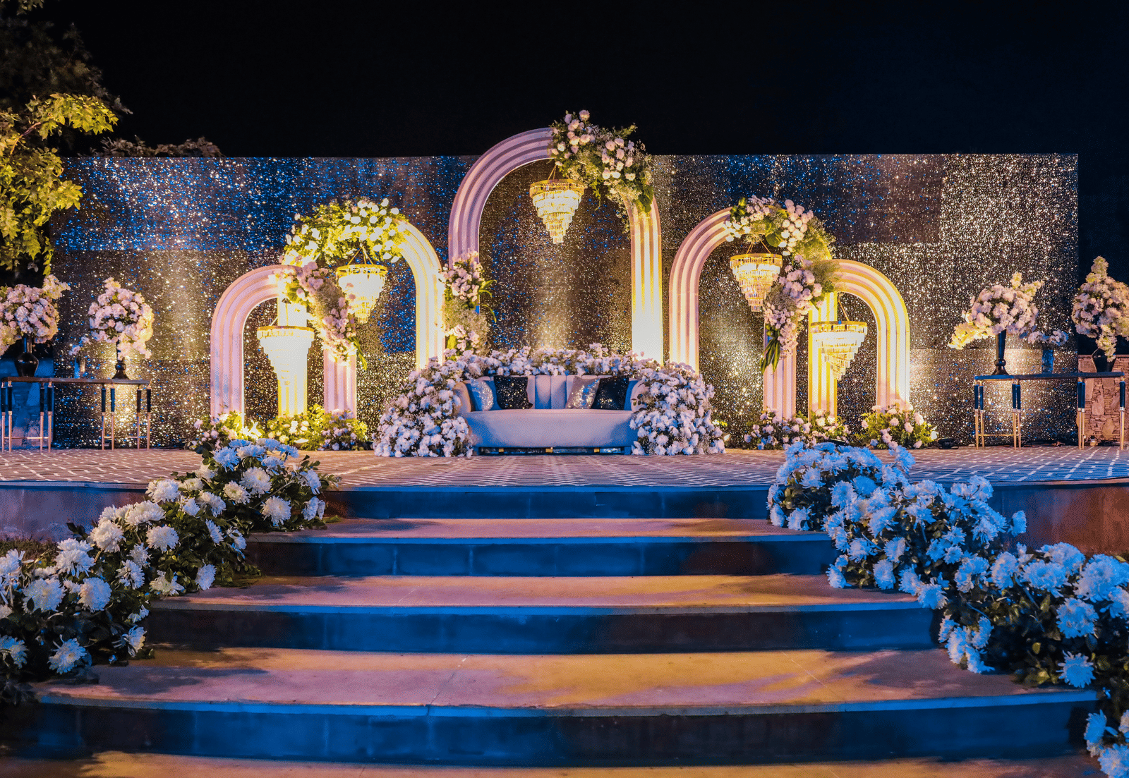 Decorated wedding stage with floral arrangements and arches at Ananta Spa and Resorts, Jaipur.