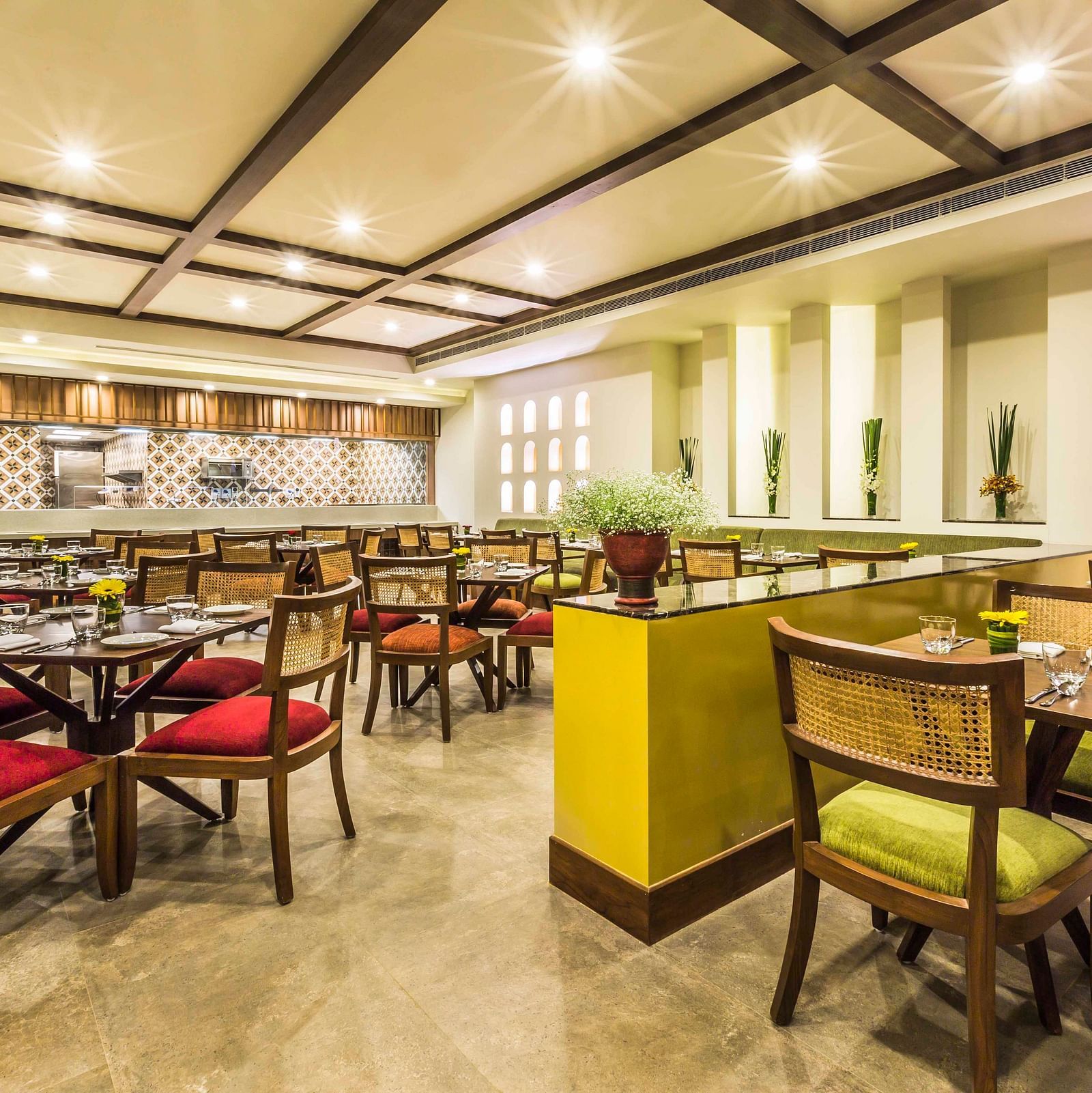 an image of a cosy cafe interiors with colourful chairs at a Lonavala restaurant and bar - Rhythm Lonavala.