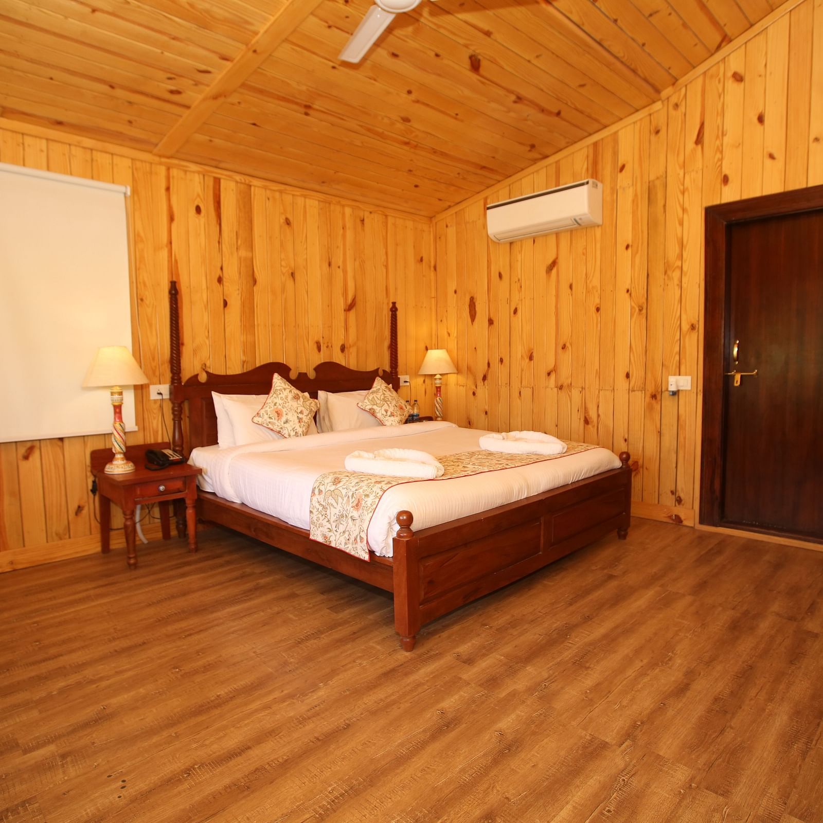 Kashmir Cottage Villa's Pool spacious room, featuring a king-sized bed and elegant wooden flooring at Aanandam Resort & Spa