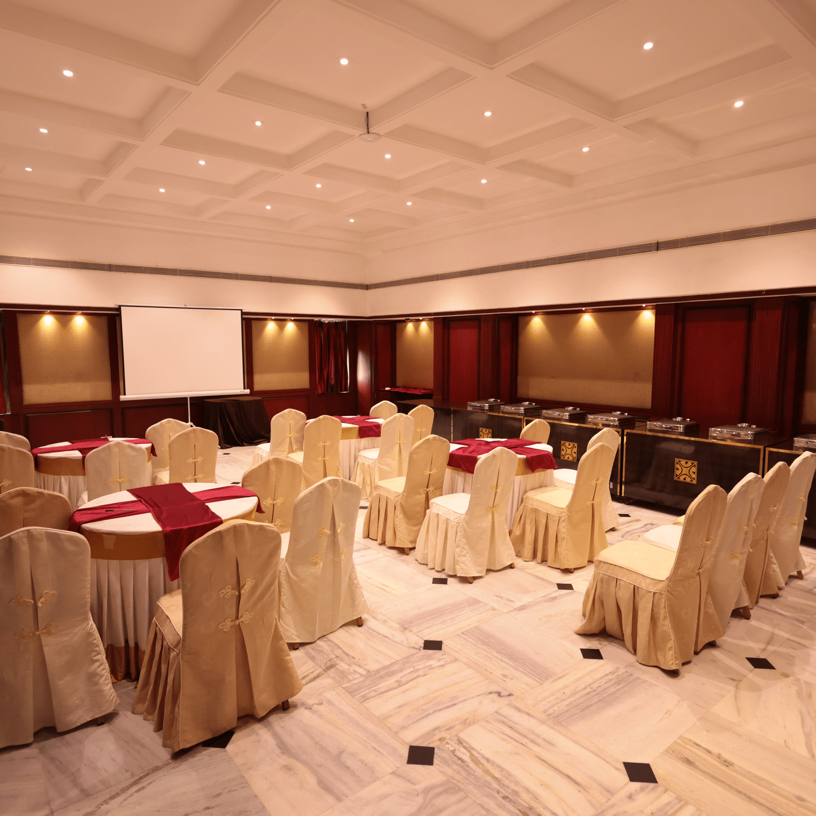 A banquet hall view from behind, with decorated tables and chairs at Cenneys Gateway.