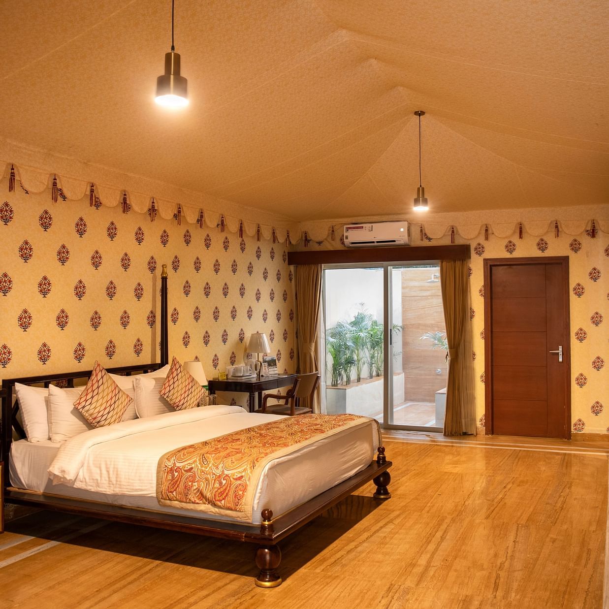 The interiors of our tent suites in Pushkar with a bed, a sofa set and tasteful decor 