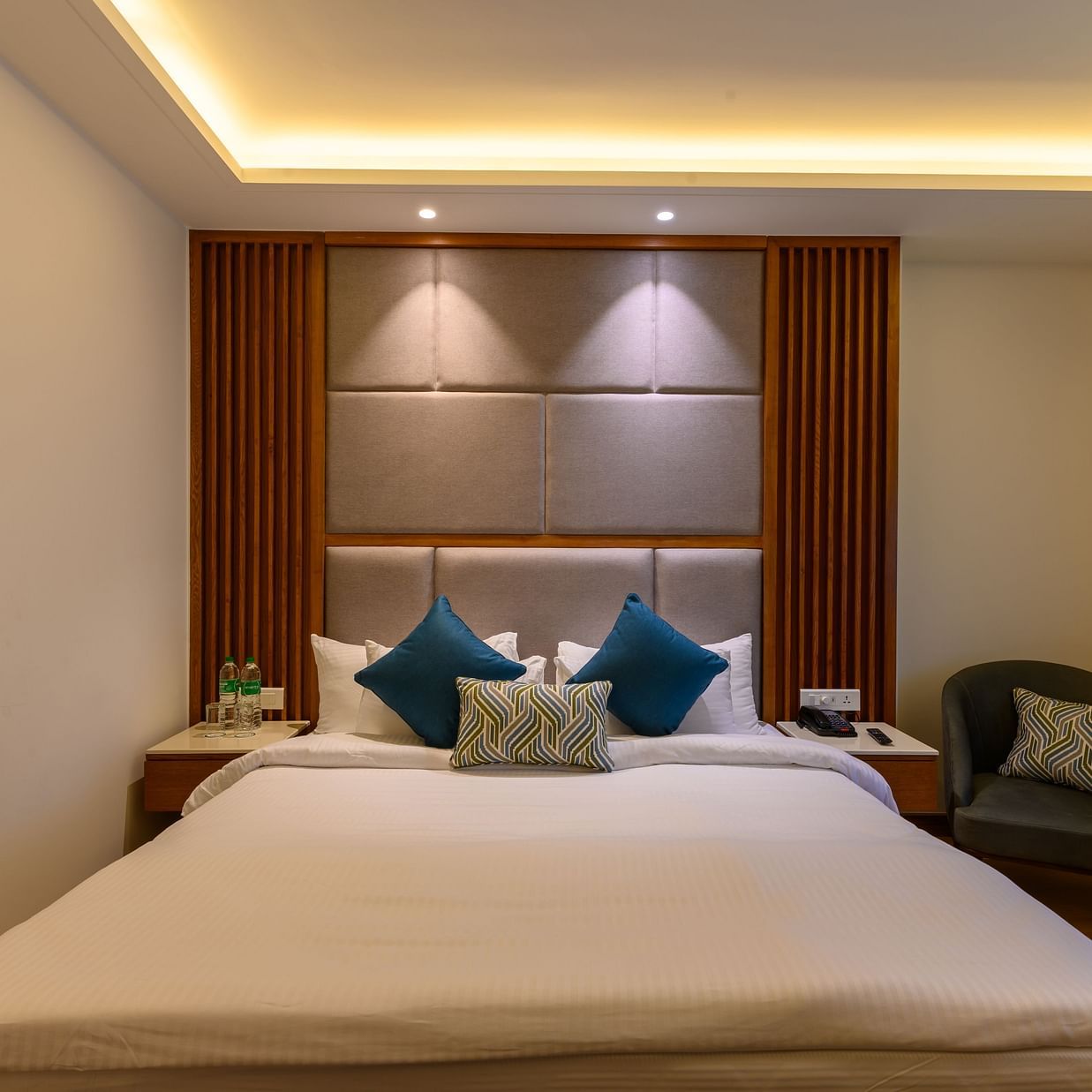 The interiors of the Classic Rooms in Pushkar featuring a bed, a sofa chair and exquisite furnishings at our resort 135