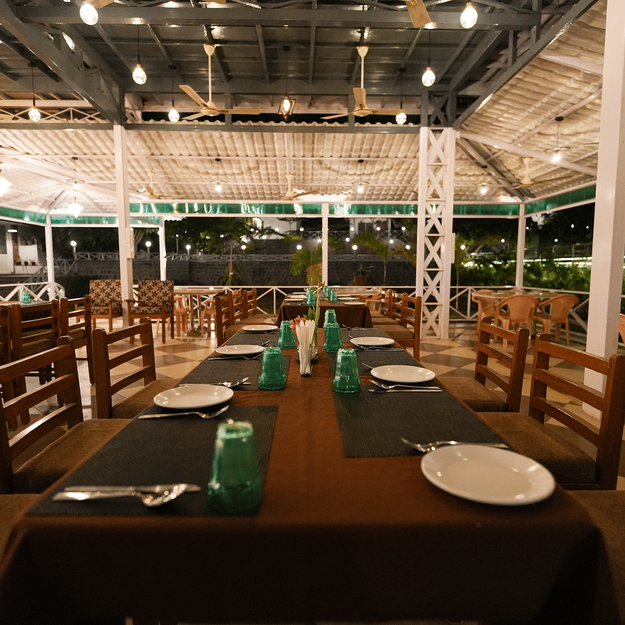 Picture featuring the restaurant, with dining tables arranged and brightly lit.