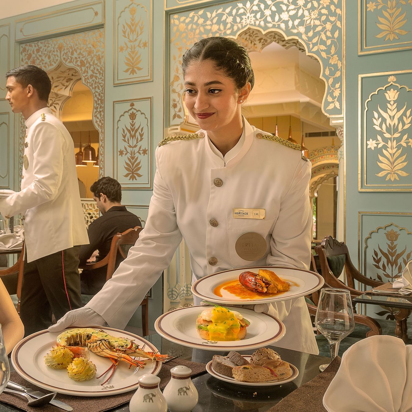 An image of  a waiter serving food to the customers