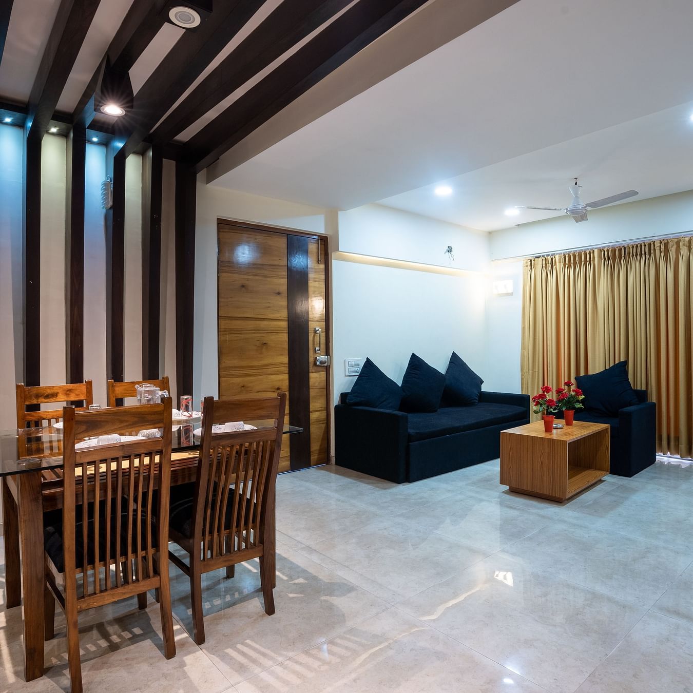 Home2 Suites & Service Apartments, Mumbai Airport - sofas and dining table in the living room of our 2BHK premium apartment in Santa Cruz