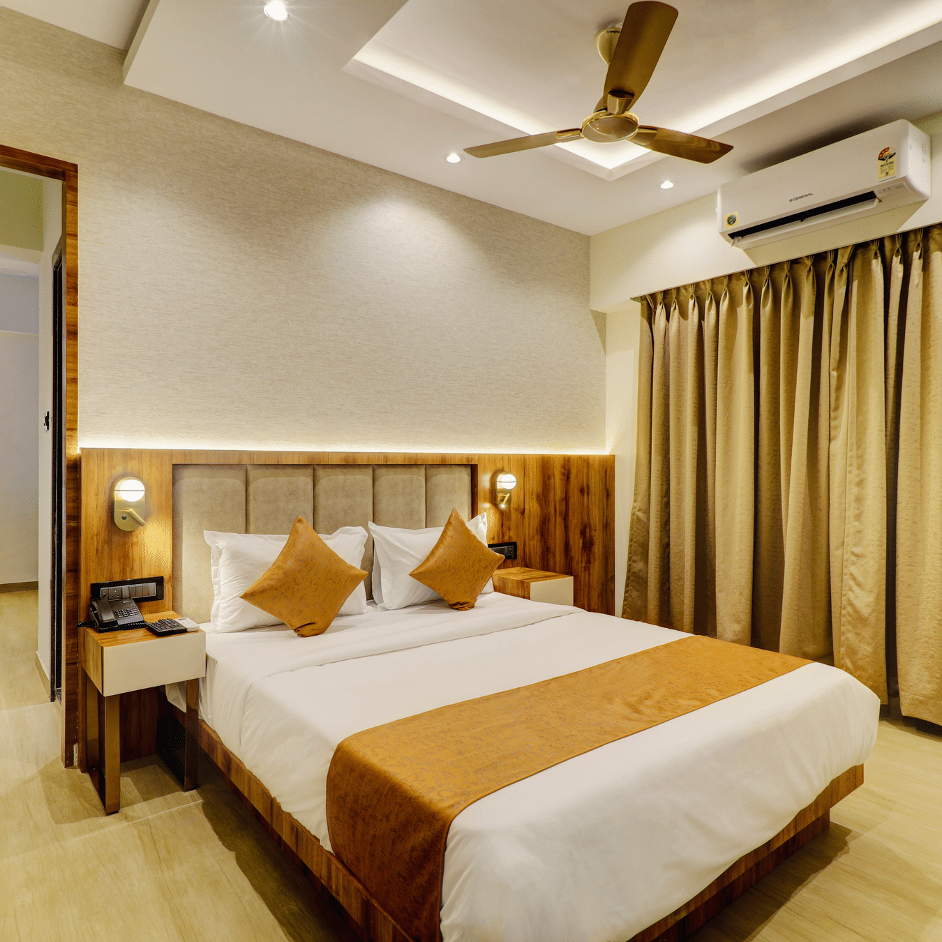 Modern deluxe room at Home2 Residency Mumbai Airport featuring a queen-size bed, elegant interiors, ambient lighting, and comfortable furnishings for a relaxing stay.