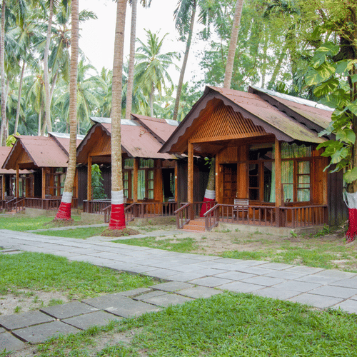 Many rows of rooms next to a paved stone pathway in a luxury resort in havelock