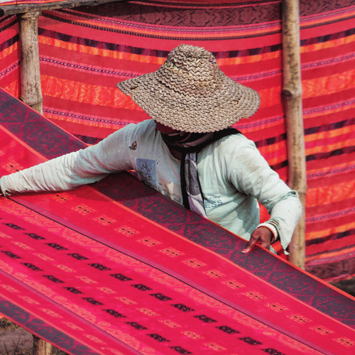 Artisan handwoven Bengali textiles and sarees displayed at a local craft market.