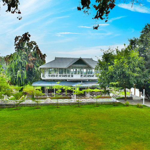 picture of a Huge building with a lawn in the front captured in  the day time