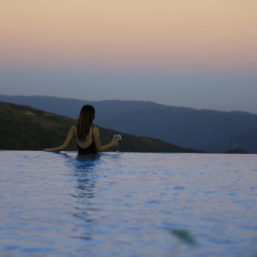 a guest looking out over the infinity swimming pool - Polo Cherrapunjee Resort