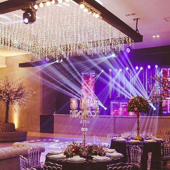 A banquet hall with a large chandelier and disco lights