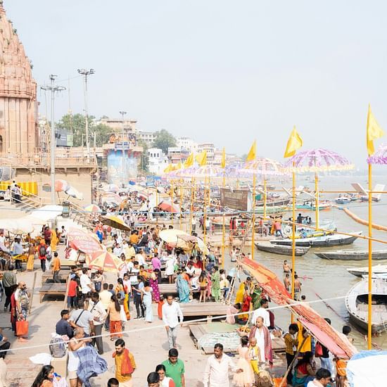 a wide angle shot of the ghats of Prayagraj filled with visitors and locals