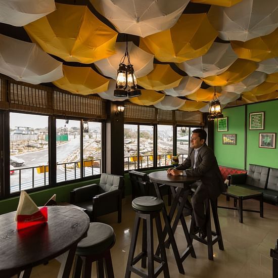 indoor sitting area at one of the restaurants with umbrellas hanging form the ceiling as a decoration 2