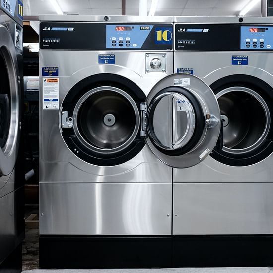 many front load washing machines stacked side by side