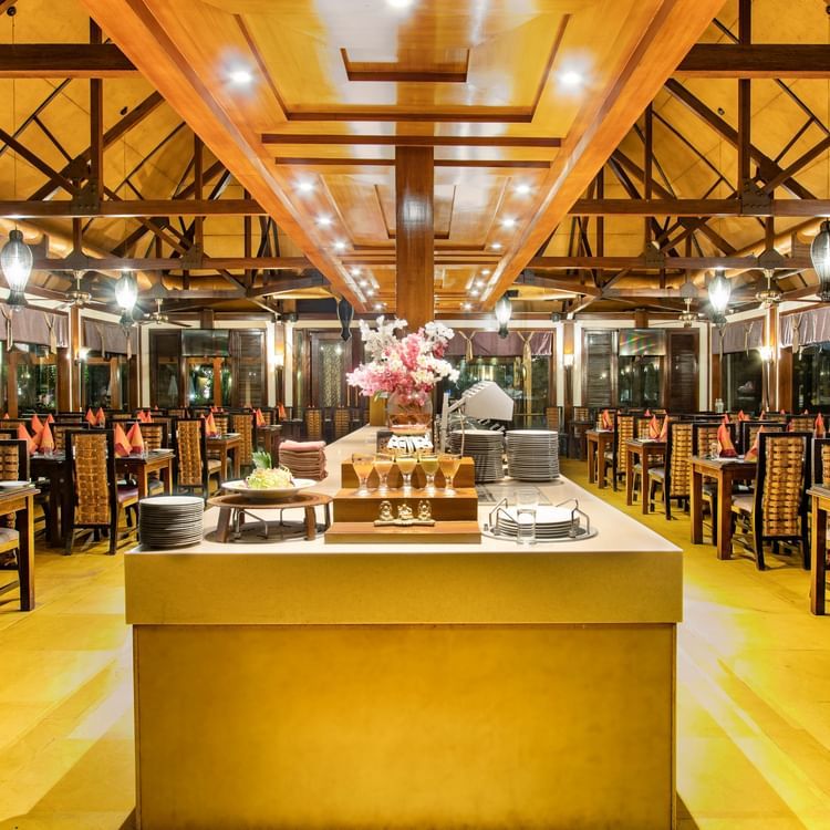 The interiors of Oasis, our multi-cuisine restaurant in Pushkar with tables and chairs and a buffet table 