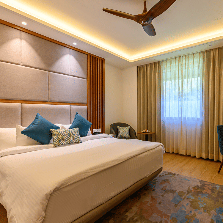 The interiors of the Classic Rooms in Pushkar featuring a bed, a sofa chair and exquisite furnishings at our resort 131