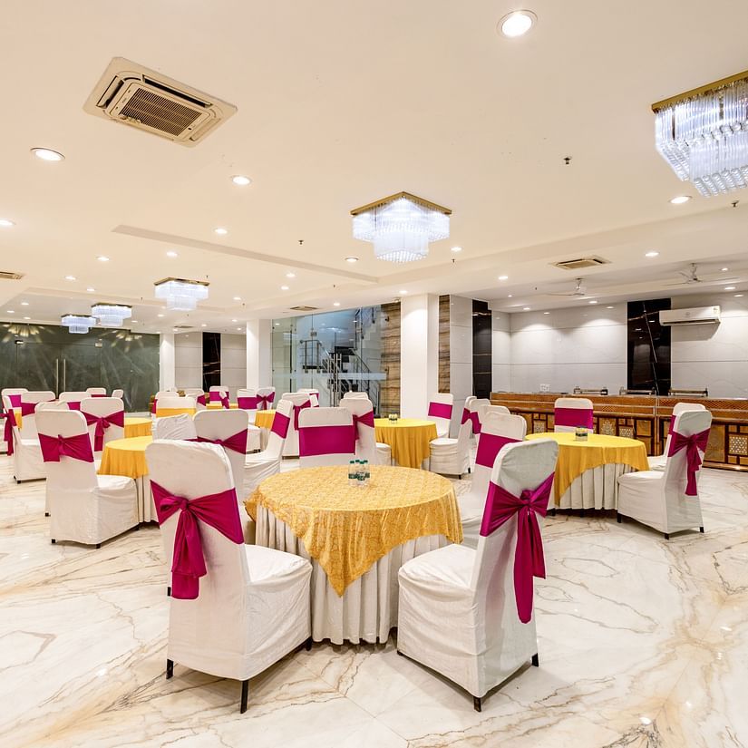 Large event space at Hotel Bawa, Gurgaon with bright lighting and banquet arrangements.