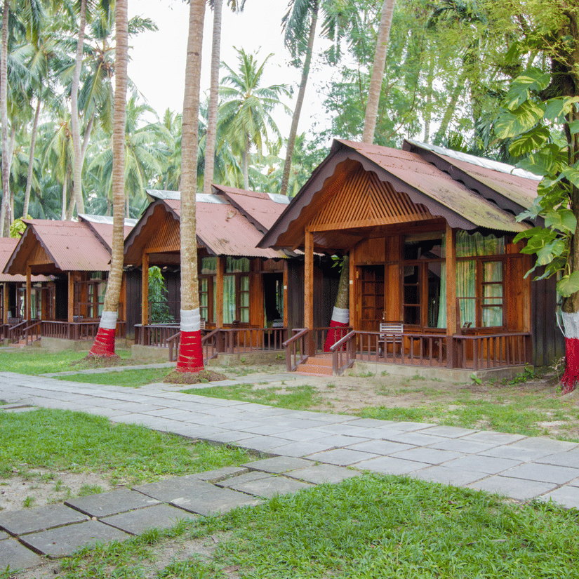 Many rows of rooms next to a paved stone pathway in a luxury resort in havelock