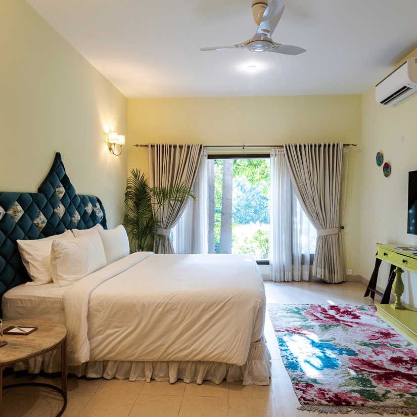 A suite of the Kingfisher Villa with a double bed and side tables - Karma Lakelands.