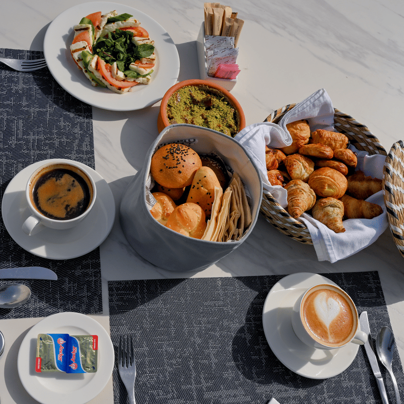 Outdoor breakfast spread with pastries, coffee and fresh salad served at La Maison Hotel, Doha.DSC 7482