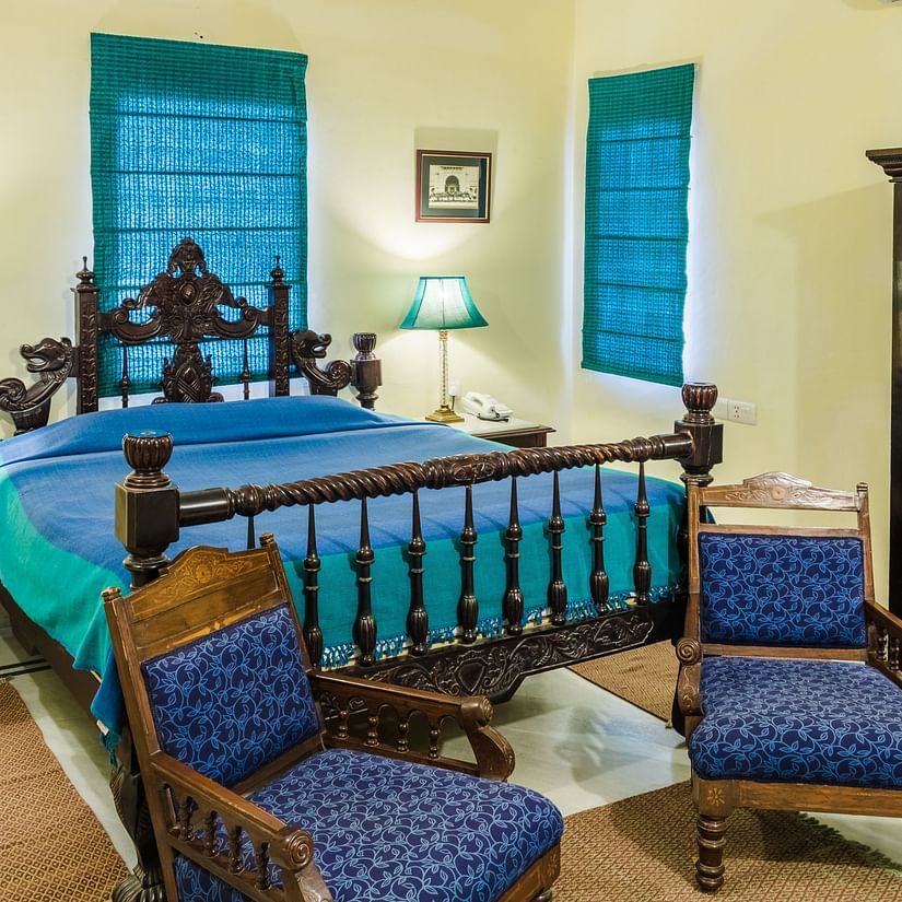 A kind bed with side tables and lamps on it inside Standard rooms - Mandawa Haveli, Jaipur