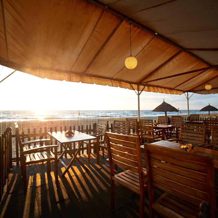 The outdoor seating arrangement at MGM Sea Crest Southern Sojourn Restaurant with views of the sea
