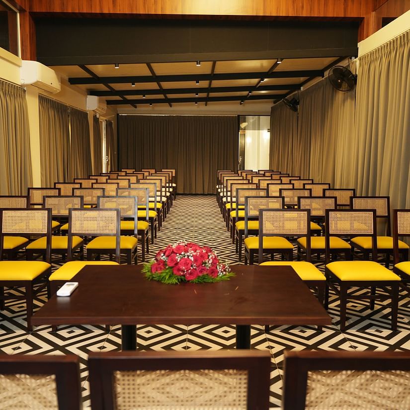 A front view of chairs placed in a classroom setup in a closed space
