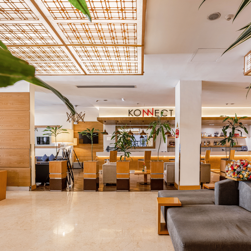 An overview of a well-lit office space of Konnect with a sofa, potted plants, a signage, and a mirror in view at Ramada by Wyndham Addis, a luxury hotel in Addis Ababa