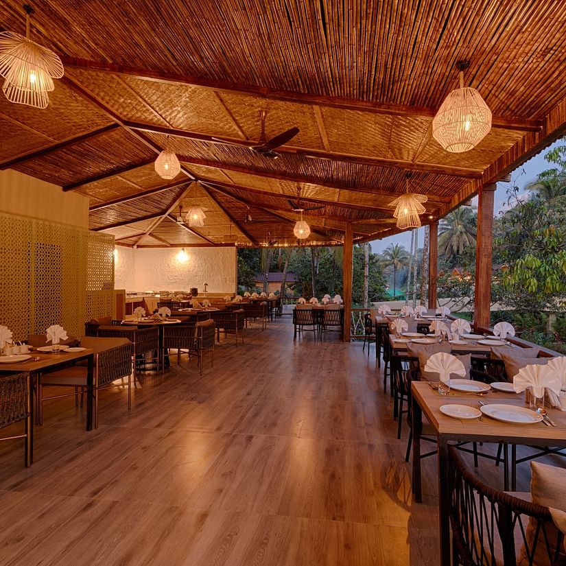 seating arrangements inside al fresco Dining with ceiling lights switched on - Stone Wood Jungle Resort, Dandeli
