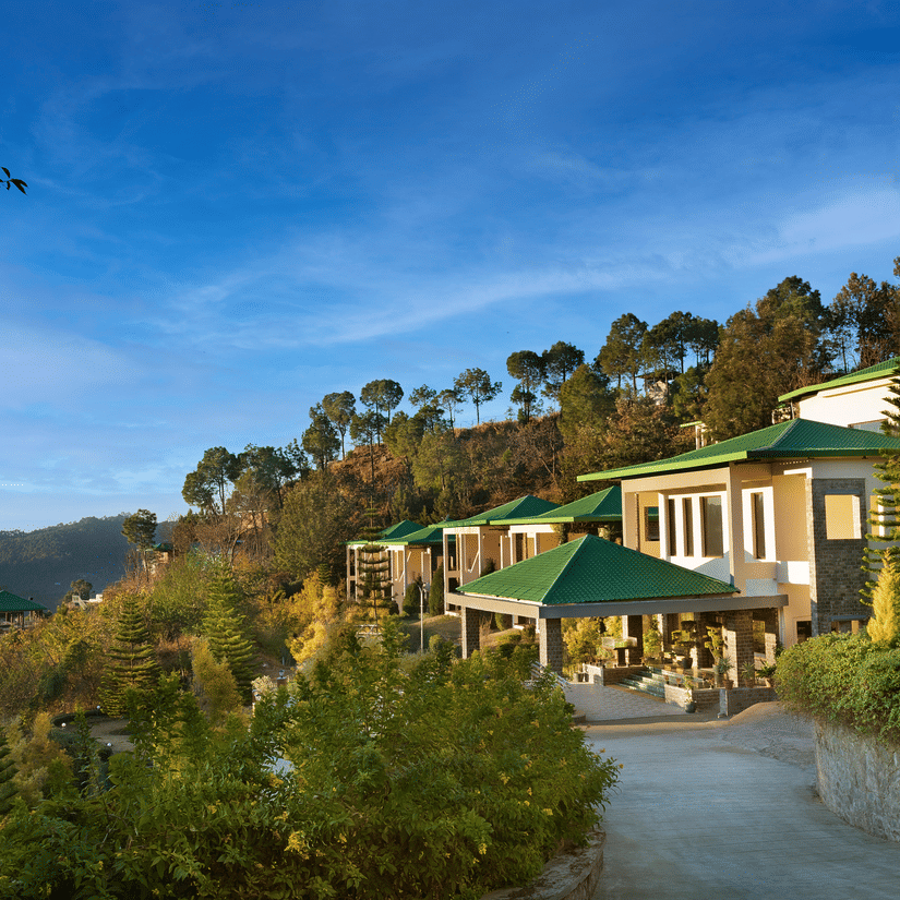 A picturesque mountain resort surrounded by lush trees, featuring stunning views of the mountains and valleys, perfect for a tranquil getaway