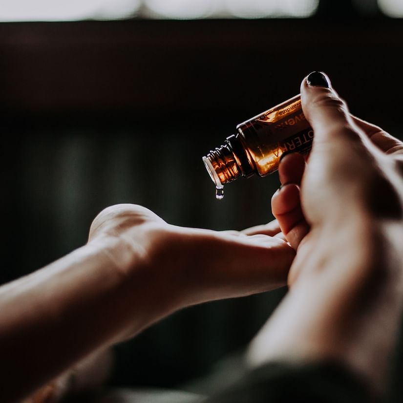 A person pouring oil onto their hands